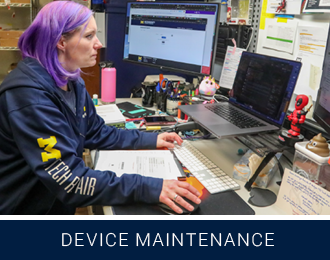 ext reads device maintenance with photo of a technician using a dual monitor set up